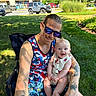 Lincoln joined the competition — help win amazing prizes! man, baby, outdoor, grass, sunglasses, tattoo, smile, child, happy, tank_top, shorts, nature, daylight, park, holding, person, greenery, building, vehicle, sunlight