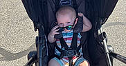 Lincoln joined the competition — help win amazing prizes! baby, babywear, casual, child, clothing, cute, footwear, infant, outdoor, pavement, person, playful, seatbelt, shade, stroller, summer, sunglasses, sunlight, toy, transport