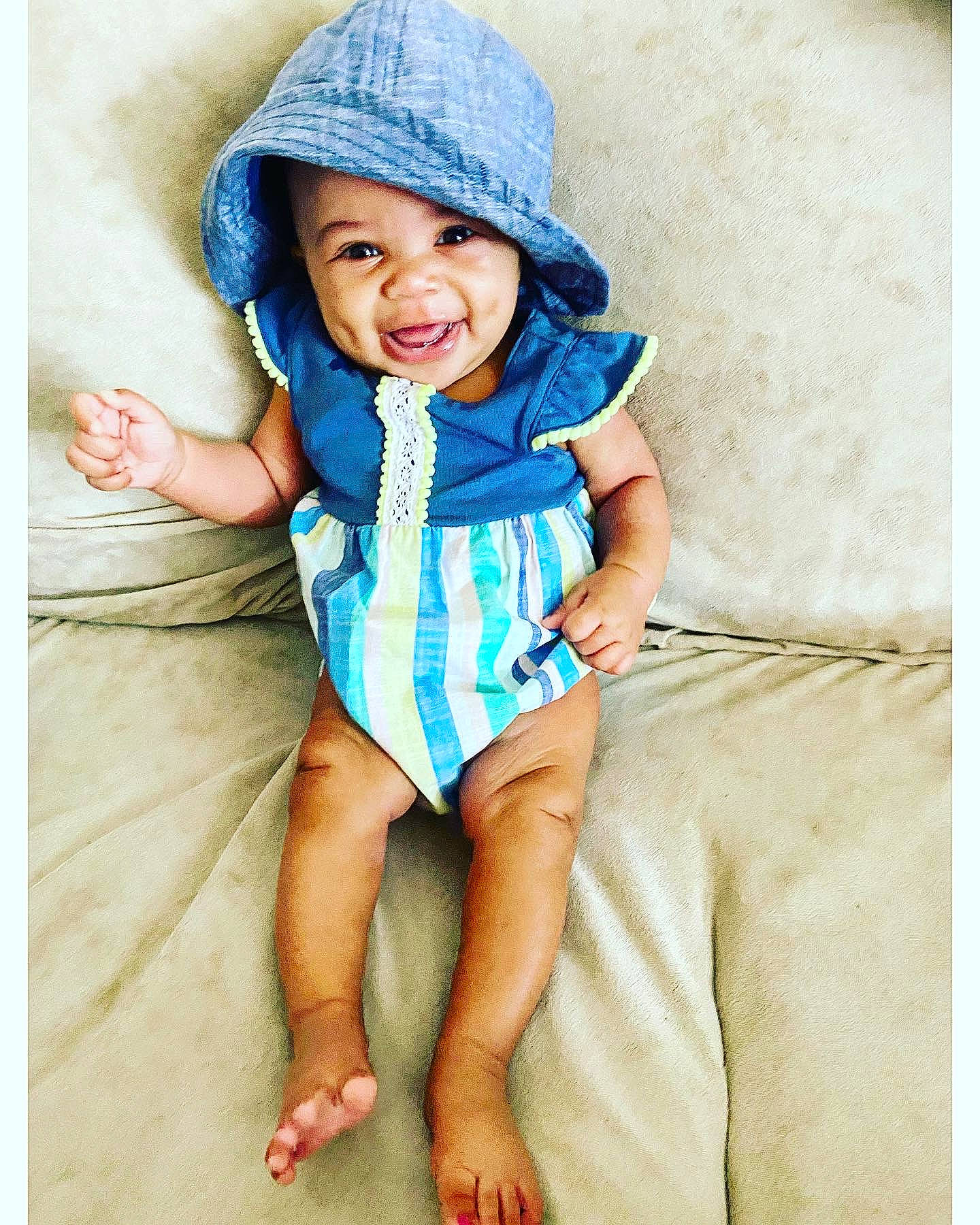 Capri joined the competition — help win amazing prizes! baby, baby_toddler_clothing, blue, cap, child, child_model, clothing, fashion_accessory, hat, headgear, headwear, person, photography, portrait_photography, sitting, smile, sun_hat, toddler, turquoise