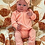 baby, blanket, bodypart, bonnet, cap, clothing, face, happy, hat, head, jeans, newborn, pants, person, photography, portrait, quilt, sitting, sleeve, smile