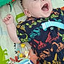 Roman is registered to the contest to win money with this photo: baby, laughing, infant, plush_toy, colorful_clothing, construction_vehicles, blanket, animal_print, rattle, soft_toys, blue_stripes, smile, cute, child, happy, lying_down, indoors, playtime, fabric, toy_cube