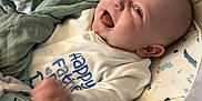 Roman is registered to the contest to win money with this photo: baby, baby_seat, blanket, child, clothing, comfort, cozy, cute, dinosaur_print, face, hand, happy, head, indoors, infant, laughing, onesie, person, seat_belt, smiling