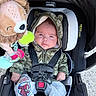Emiliano joined the competition — help win amazing prizes! baby, infant, child, car_seat, harness, hoodie, camouflage, spiderman, pants, plush_toy, lion, toy, portrait, sitting, indoors, vehicle,  안전, smiling, headrest, photography