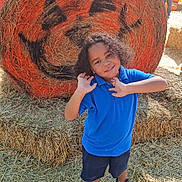 Rayden joined the competition — help win amazing prizes! child, boy, smiling, blue_shirt, neon_sneakers, hay_bale, jack_o_lantern, pumpkin_face, autumn, fall_festival, straw, outdoor, playful, curly_hair, festival, decoration, sunny_day, casual_clothing, fun, posing