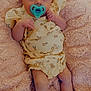 baby, pacifier, blanket, yellow_clothing, floral_pattern, infant, lying_down, cute, soft_texture, skin, legs, arms, small_hands, portrait, indoors, baby_girl, newborn, comfort, child, resting