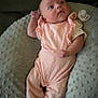 Carolynn is registered to the contest to win money with this photo: baby, child, clothing, cushion, cute, face, foot, hand, head, indoor, infant, looking_up, newborn, person, pillow, pink_outfit, relaxing, skin, sleepwear, soft_texture