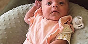 Carolynn is registered to the contest to win money with this photo: baby, child, closeup, comfort, cozy, curious, cushion, cute, expression, home, indoor, infant, newborn, pacifier, person, pink_clothing, portrait, resting, seated, soft_texture