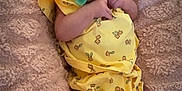 Carolynn joined the competition — help win amazing prizes! baby, infant, pacifier, yellow_clothing, blanket, pink_blanket, floral_pattern, lying_down, cute, wide_eyes, cozy, soft_texture, small_hands, bare_legs, indoors, portrait, child, newborn, comfort, resting