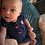 baby, infant, child, face, eyes, clothing, polka_dot, pink_bows, navy_blue, cushion, blanket, soft, cozy, indoor, portrait, cute, expression, hand, foot, skin