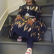 Dayana participe au concours pour gagner de l'argent avec cette photo : accessory, casual, child, cute, decor, dress, fashion, footwear, girl, happy, home, indoor, person, portrait, seated, smile, socks, stairs, tiara, young