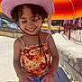 architecture, baseballcap, cap, child, city, clothing, face, female, girl, hat, head, pants, person, photography, portrait, road, street, summer, sunhat, urban