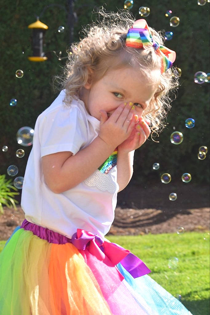 Suzie is registered to the contest to win money with this photo: baby_toddler_clothing, beauty, blond, botany, child, event, fun, grass, hairstyle, happy, iris, leaf, leisure, light, people_in_nature, person, photograph, pink, standing, summer