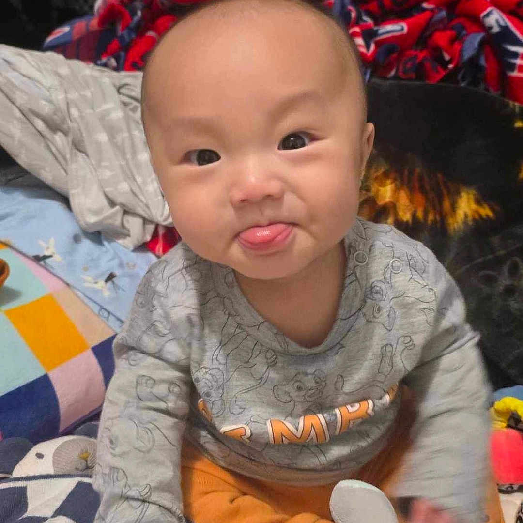 Brady joined the competition — help win amazing prizes! baby, bed, bedroom, clothing, couch, cushion, face, furniture, happy, head, homedecor, indoors, person, photography, portrait, quilt, room, sitting, smile, t_shirt