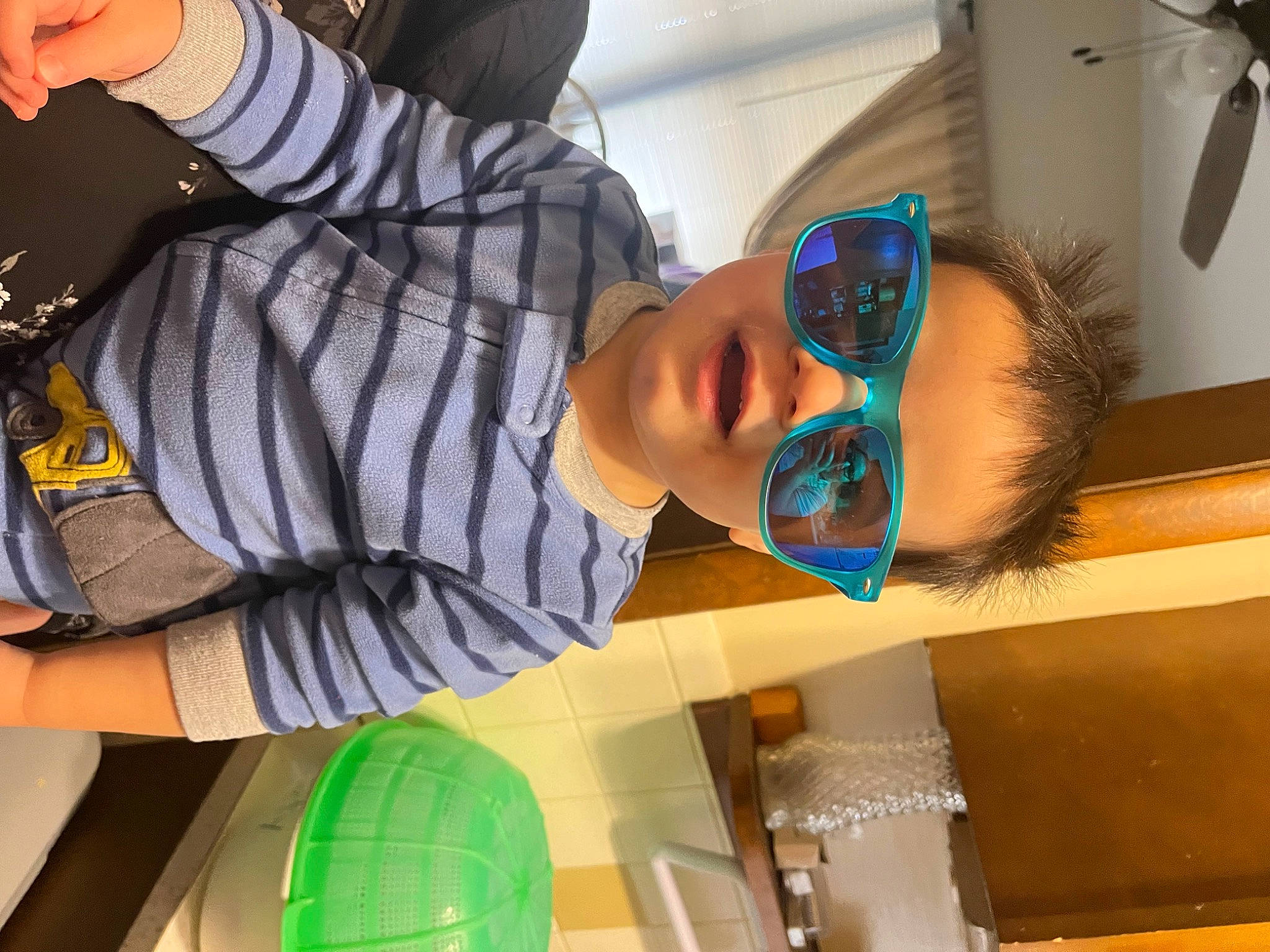 Noah is registered to the contest to win money with this photo: baby, ceiling_fan, child, eyewear, fun, happy, hat, leisure, person, room, t_shirt, toddler, yellow