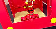 Lyzio participe au concours pour gagner de l'argent avec cette photo : child, firefighter_costume, red_helmet, play_structure, fire_truck, toy, imaginative_play, indoor, wooden_floor, red_color, yellow_detail, steering_wheel, curious, costume, pretend_play, kid, young_child, fun, role_play, bright_colors