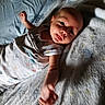 Atlas joined the competition — help win amazing prizes! baby, infant, blanket, bed, sleepwear, face, tongue, arm, hand, skin, person, cute, lying_down, expression, indoors, soft_texture, young_child, resting, comfort, closeup