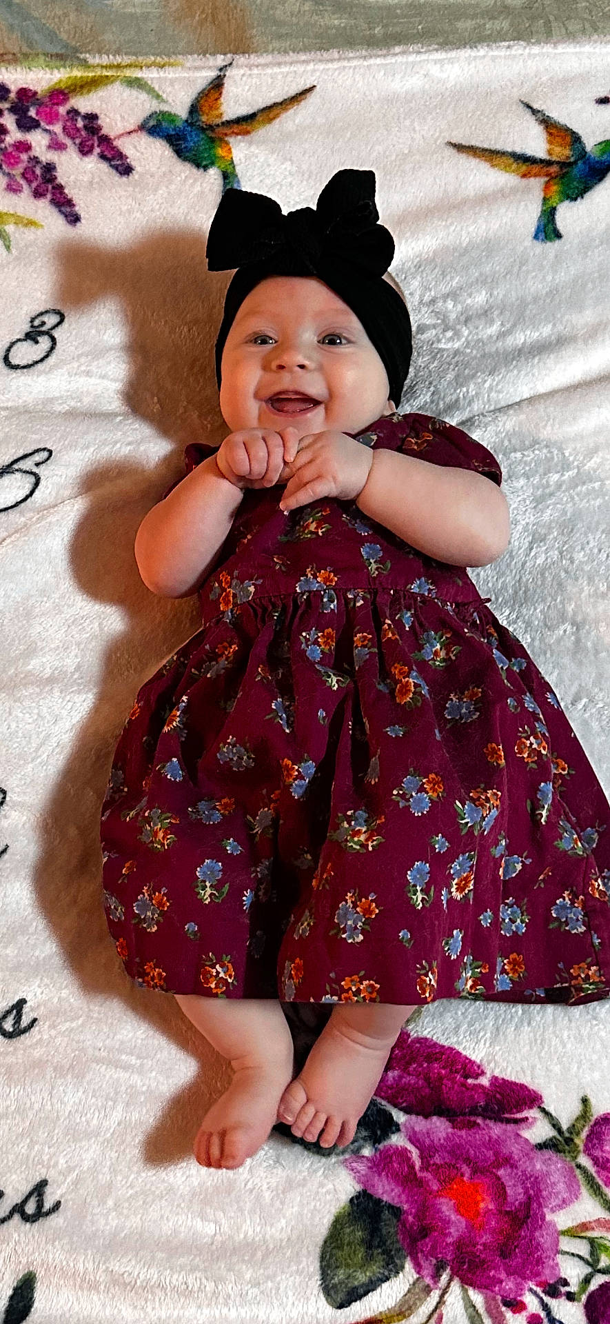 animal, applique, baby, bird, bodypart, bonnet, cap, clothing, dress, face, finger, formalwear, hand, hat, head, pattern, person, photography, portrait, purple