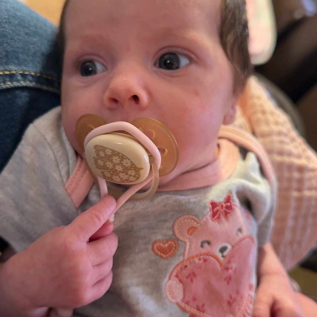 Amethyst joined the competition — help win amazing prizes! baby, infant, child, portrait, sitting, pacifier, wide_eyed, clothing, bear_design, onesie, blanket, lap, hand, indoor, home, cozy, close_up, face, baby_girl, photograph