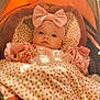 baby, blanket, bow, child, clothing, cozy, cute, face, hands, headband, indoor, infant, pink, polka_dot, portrait, resting, soft_texture, stroller, warm_light, young_child