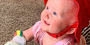 Renley joined the competition — help win amazing prizes! baby, red_hat, pink_shirt, carpet, plush_toy, child, indoor, smiling, cute, infant, happy, playing, young_child, blue_eyes, soft_toys, floor, person, headwear, expression, toddler