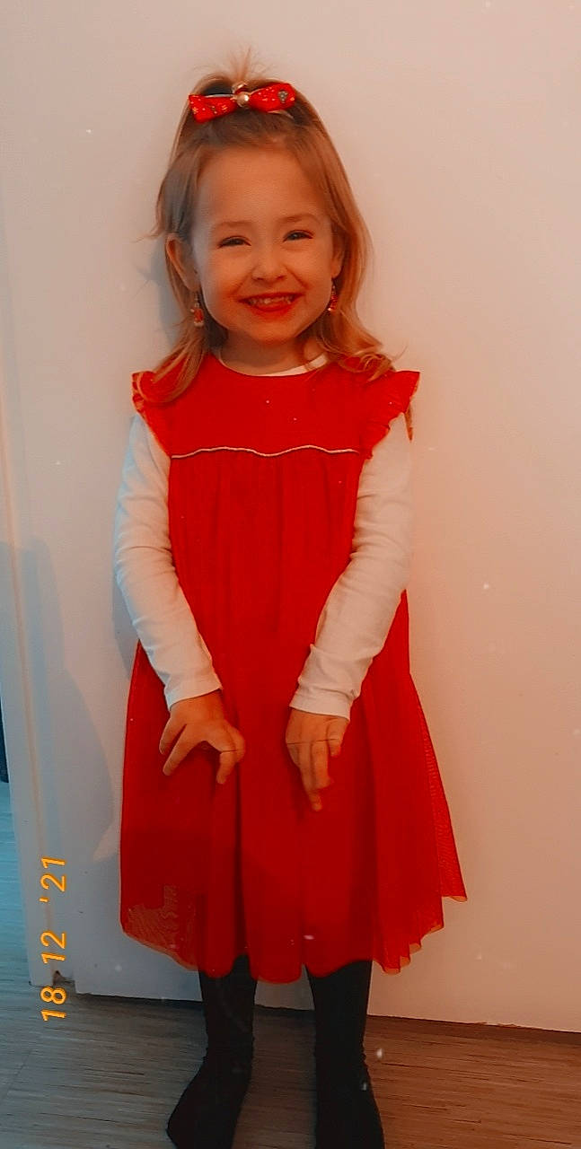 Lily participe au concours pour gagner de l'argent avec cette photo : baby_toddler_clothing, clothing, day_dress, dress, embellishment, fashion_design, iris, joint, joy, neck, one_piece_garment, person, pink, red, shoulder, skin, sleeve, smile, standing, toddler