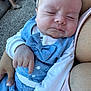 baby, infant, sleeping, blue_bow_tie, white_shirt, person, hand, arm, outdoor, stroller, fabric, skin, closeup, peaceful, nap, cute, child, holding, casual, fingers