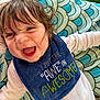 Wesley is registered to the contest to win money with this photo: baby, smiling, bib, blue, white_clothing, blanket, plush_toy, green, pattern, happy, face, child, infant, caterpillar_toy, toddler, cute, indoors, portrait, joyful, closeup