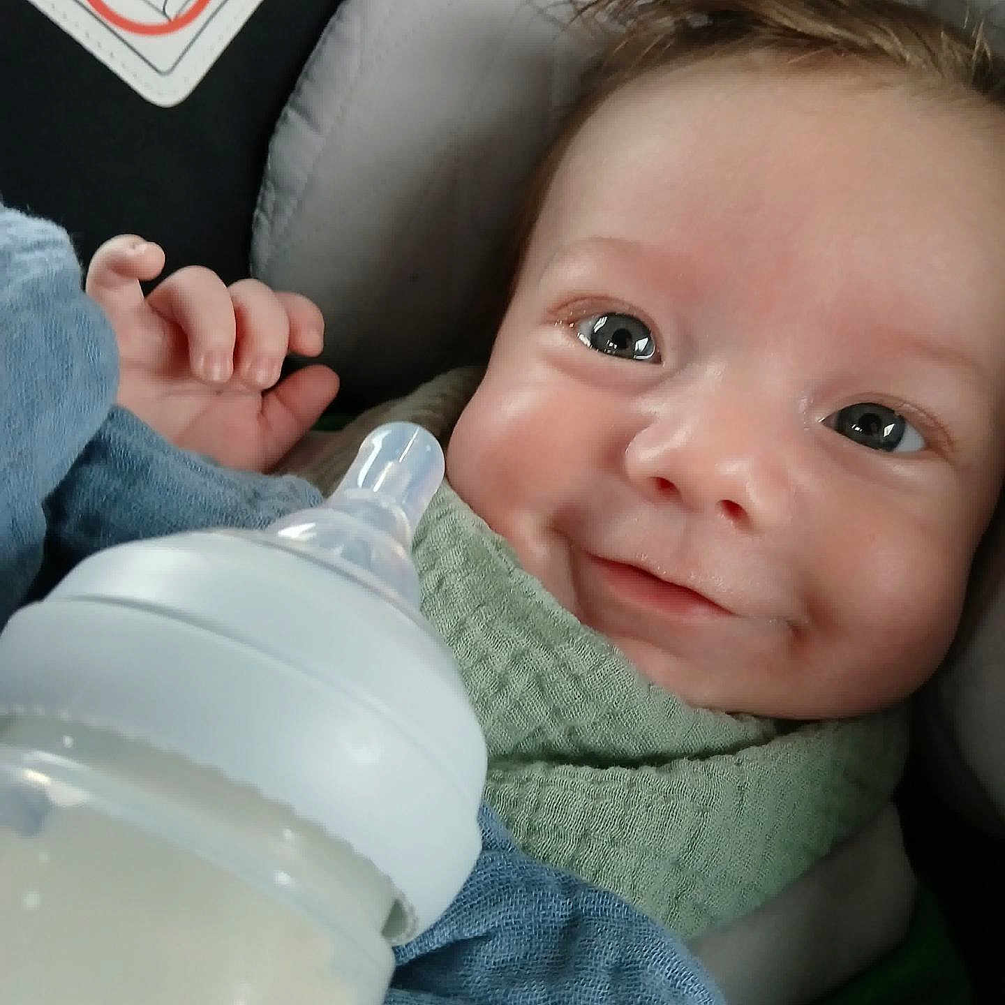 Elijah joined the competition — help win amazing prizes! baby, beverage, bodypart, bottle, clothing, cushion, face, finger, furniture, hand, happy, head, homedecor, milk, newborn, pants, person, photography, portrait, smile