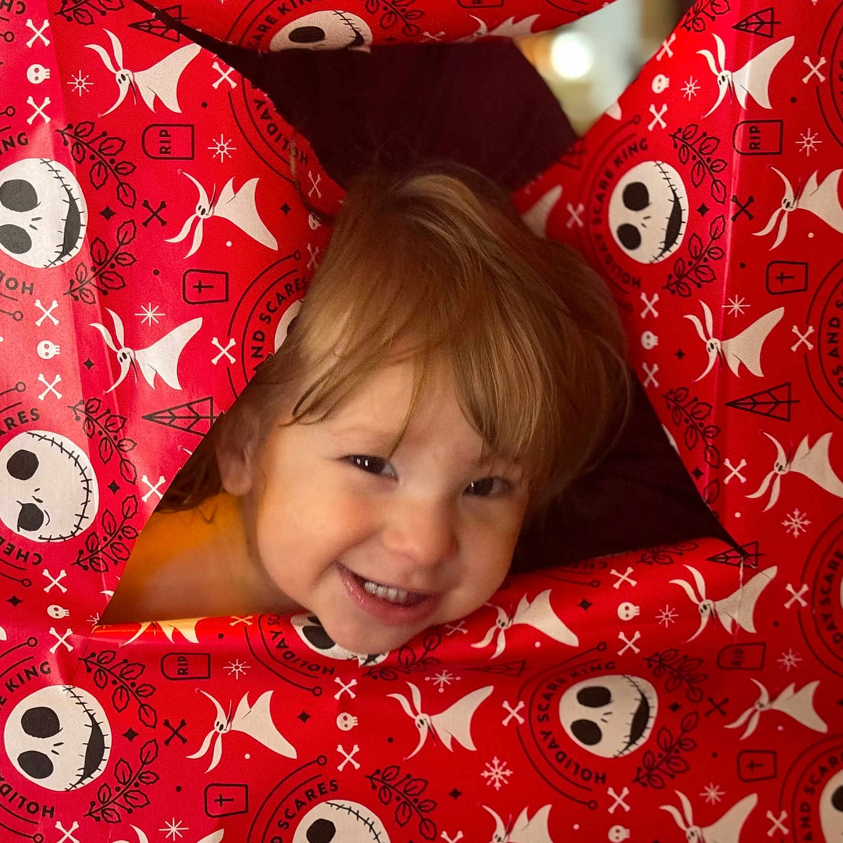 Ragnar is registered to the contest to win money with this photo: baby, blanket, bodypart, clothing, coat, cushion, face, furniture, happy, head, homedecor, laughing, mouth, pajamas, person, photography, portrait, quilt, smile, teeth