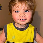 Ryder joined the competition — help win amazing prizes! toddler, child, smiling, yellow_shirt, blonde_hair, blue_eyes, indoor, sitting, tank_top, graphic_tshirt, cute, happy, face, person, shorts, playful, young_child, casual_clothing, portrait, closeup