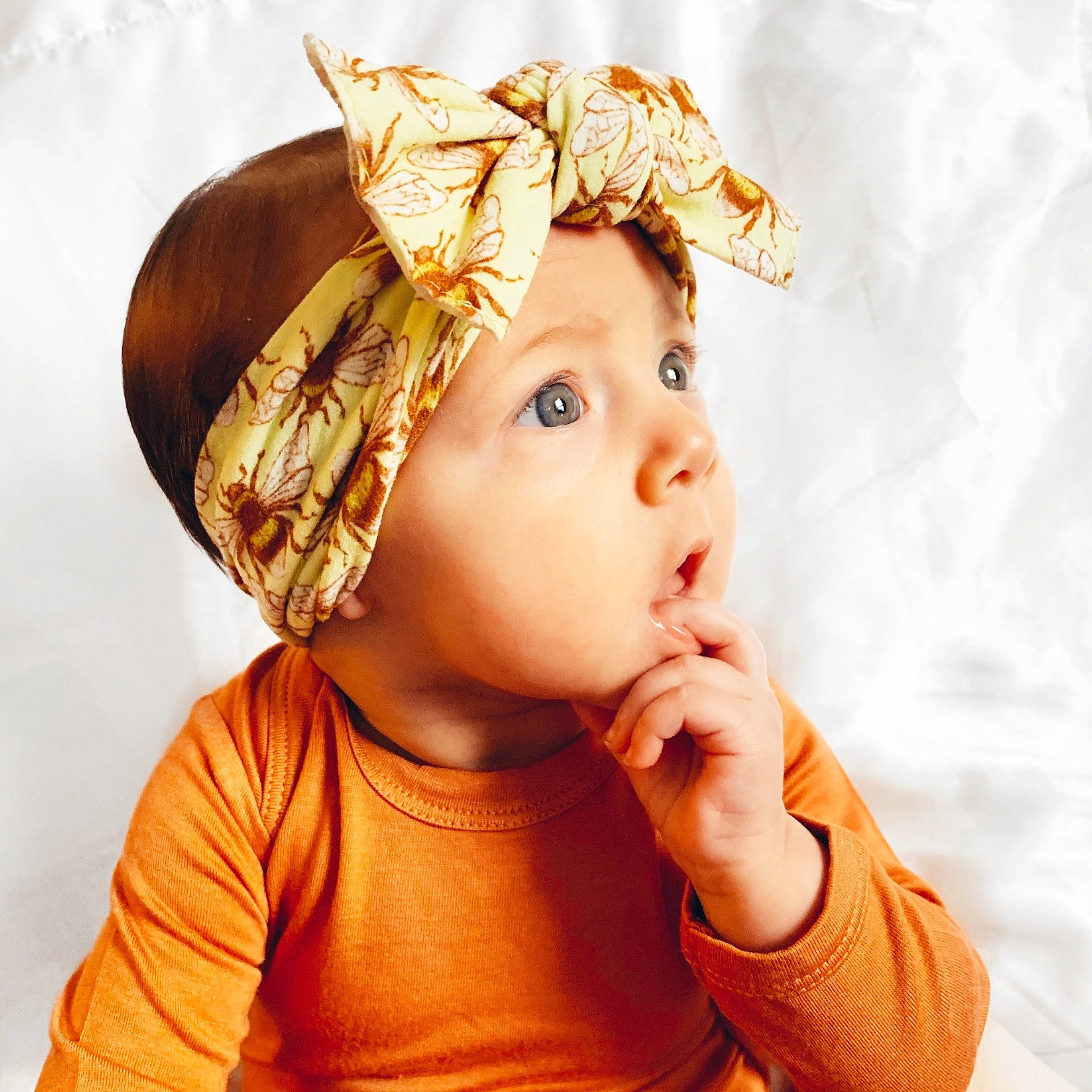 Stevie is registered to the contest to win money with this photo: baby, child, child_model, clothing, ear, fashion_accessory, hair_accessory, hat, head, headgear, headpiece, person, toddler