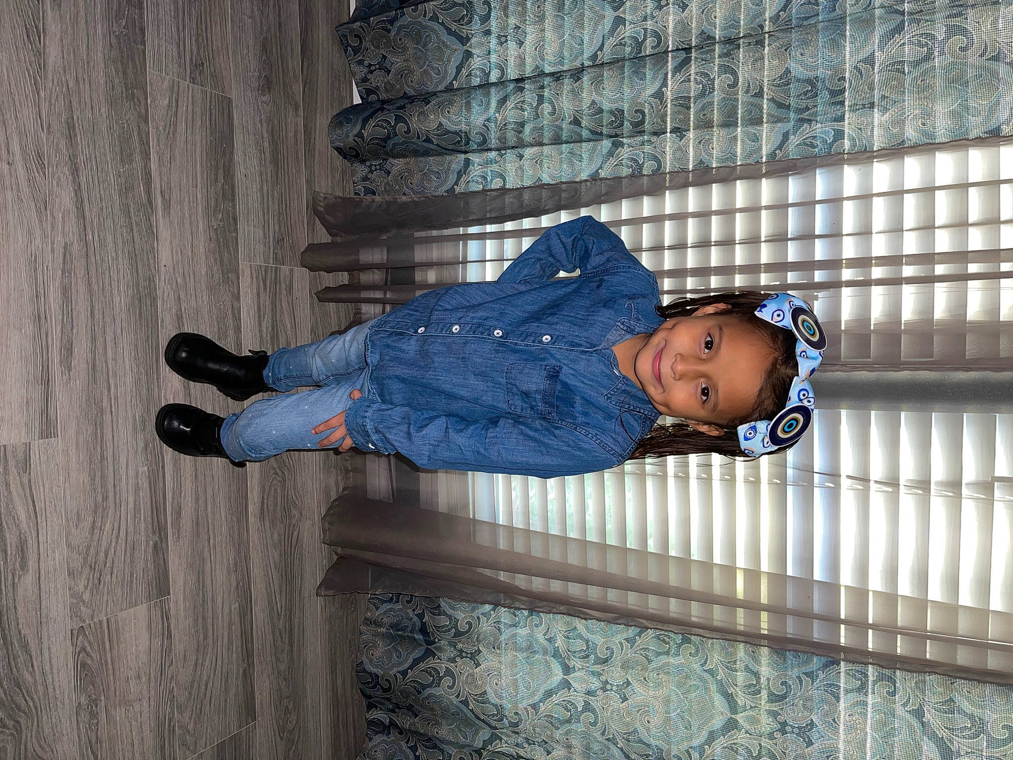 Jaylah is registered to the contest to win money with this photo: baby_toddler_clothing, child, clothing, composite_material, concrete, denim, electric_blue, flooring, fun, human_leg, joy, pattern, person, shadow, sitting, sleeve, smile, street_fashion, toddler, tree