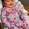 Kea'Laiah is registered to the contest to win money with this photo: baby, infant, child, smiling, portrait, indoors, blanket, onesie, strawberry_pattern, colorful_clothing, lying_down, happy, face, eyes, hair, wood_floor, home, cozy, motion_blur, bedding