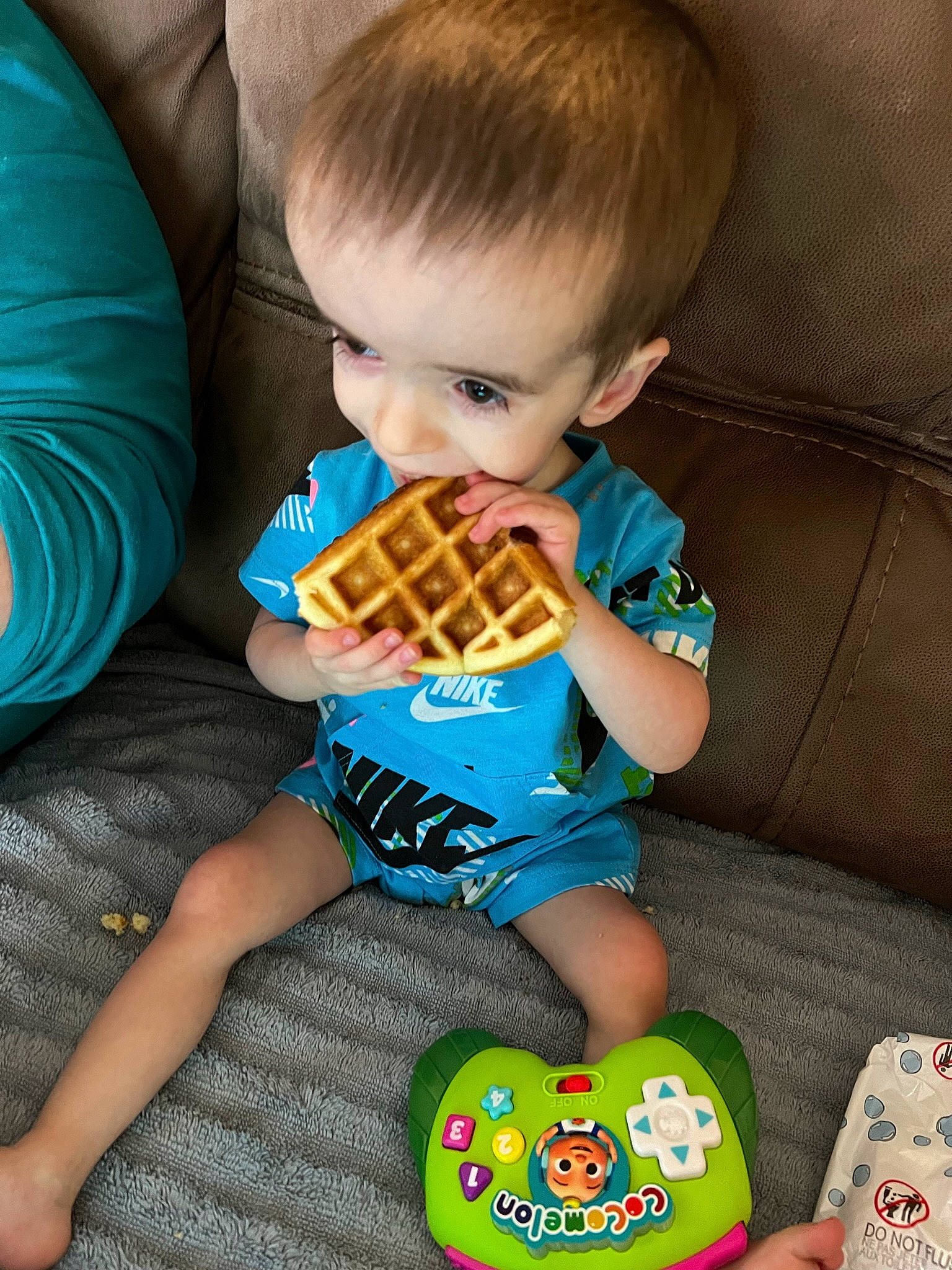 Nathan is registered to the contest to win money with this photo: baby, baby_playing_with_toys, baby_toddler_clothing, blue, child, comfort, comfort_food, couch, fictional_character, fun, holiday, lap, pattern, person, play, sitting, sleeve, sock, toddler