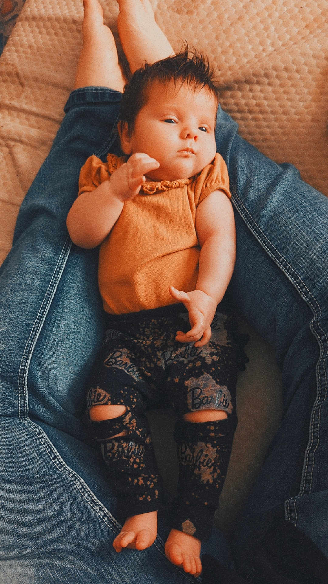 Copelynn joined the competition — help win amazing prizes! baby, child, infant, denim, jeans, leggings, orange_top, barefoot, legs, relaxed, indoor, blanket, patterned_clothing, person, portrait, cute, casual, resting, skin, hair
