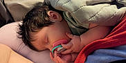 Copelynn is registered to the contest to win money with this photo: baby, bed, blanket, child, closeup, comfort, cozy, cute, face, hair, hand, indoor, infant, pacifier, peaceful, relaxation, rest, skin, sleeping, soft_lighting