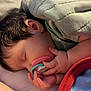Copelynn is registered to the contest to win money with this photo: baby, sleeping, pacifier, blanket, hand, face, infant, cozy, soft_lighting, bed, comfort, cute, child, closeup, skin, hair, peaceful, rest, indoor, relaxation