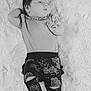 baby, infant, lying_down, blanket, clothing, pants, barbie, relaxed, cute, soft_texture, monochrome, portrait, small_hands, feet, hair, child, young, sleepwear, resting, cozy