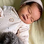 baby, newborn, sleeping, infant, onesie, hat, plush_toy, blanket, cozy, cute, peaceful, child, soft, clothing, face, portrait, resting, indoors, toddler, closeup