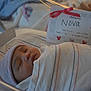 newborn, baby, hospital, blanket, bassinet, hat, sleeping, infant, sign, mickey_mouse, minnie_mouse, person, child, crib, striped, cute, resting, portrait, indoors, hospital_room