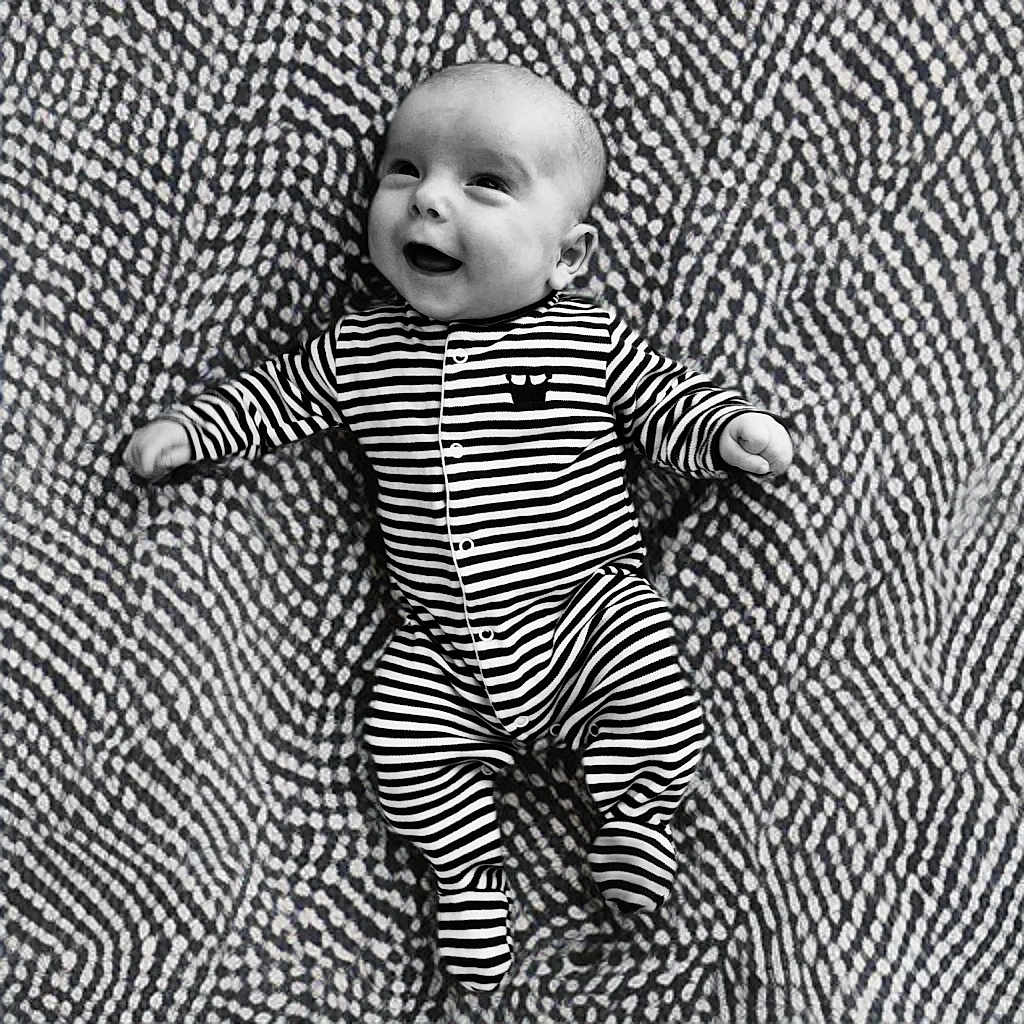 Kas joined the competition — help win amazing prizes! baby, black_and_white, blanket, child, cozy, cute, face, foot, hand, happy, head, infant, lying_down, monochrome, onesie, patterned_blanket, portrait, smiling, striped_clothing, texture