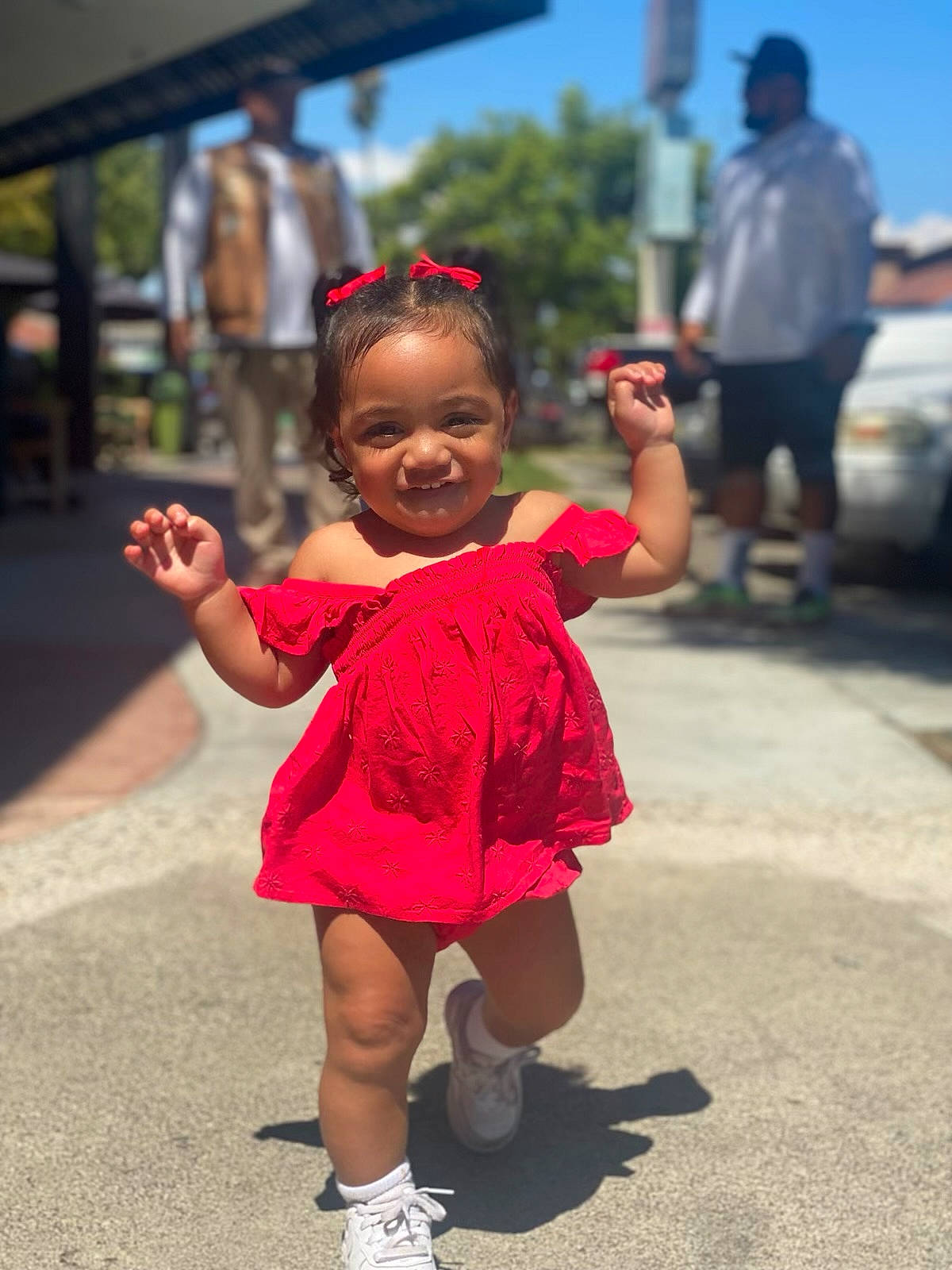 Avyanna is registered to the contest to win money with this photo: asphalt, child, event, fun, gesture, happy, joy, leisure, pedestrian, person, recreation, road, sandal, sky, smile, street, toddler, tourism, tradition, tree