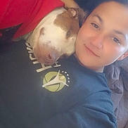 Story is registered to the contest to win money with this photo: dog, person, selfie, cuddle, indoor, couch, shirt, smile, face, pet, brown_and_white_dog, nose, eyes, lying_down, cozy, blanket, long_hair, human, portrait, relaxed