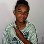 child, boy, peace_sign, hairstyle, freckles, sports_jersey, patterned_clothing, standing, portrait, casual, indoor, smiling, confident, young_person, human, tshirt, short_sleeves, youth, gesture, wall