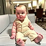 Rowan joined the competition — help win amazing prizes! baby, child, infant, sitting, clothing, vest, pants, barefoot, couch, furniture, indoor, room, lamp, table, carpet, curious, expression, cute, chubby, portrait