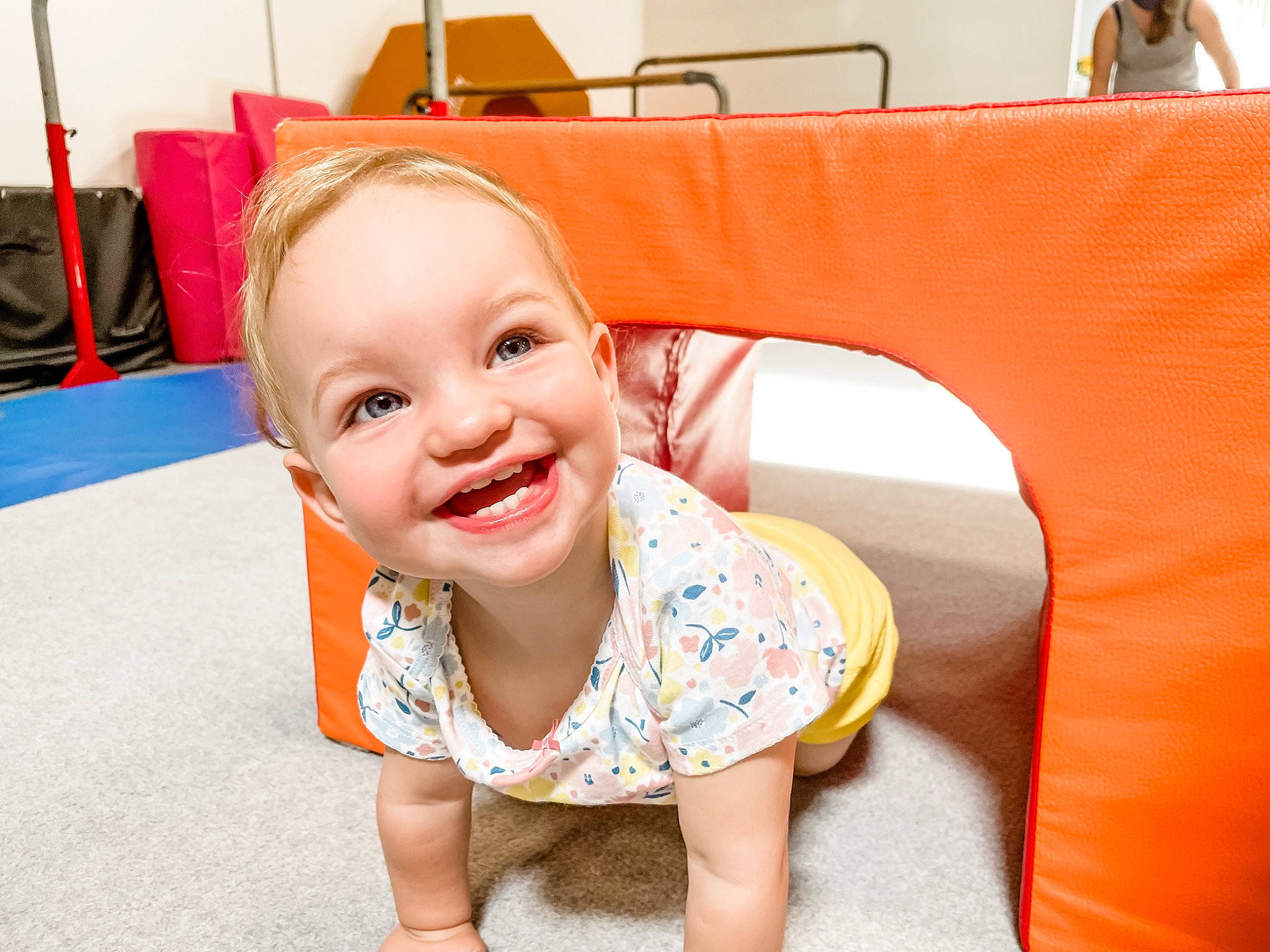 Finley is registered to the contest to win money with this photo: baby, baby_toddler_clothing, chair, child, facial_expression, flooring, fun, hairstyle, happy, joy, leisure, orange, person, recreation, room, shorts, sitting, skin, sleeve, smile