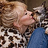 affection, animal, blonde_hair, bun, casual, close_up, coat, cute, dog, friendship, fur, indoor, jeans, kiss, leopard_print, love, pet, portrait, red_collar, woman