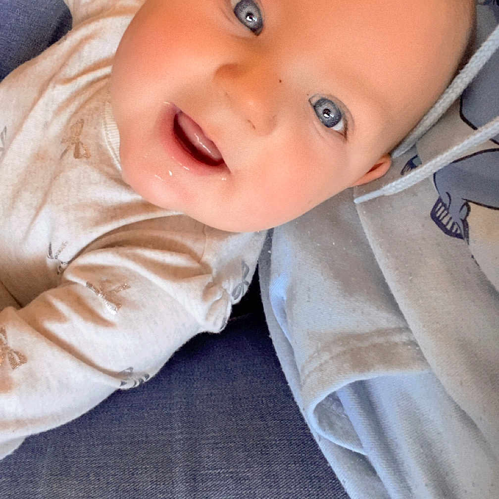Nova joined the competition — help win amazing prizes! baby, bodypart, clothing, coat, couch, face, finger, furniture, hand, happy, head, longsleeve, pants, person, photography, portrait, shirt, sleeve, smile, wood