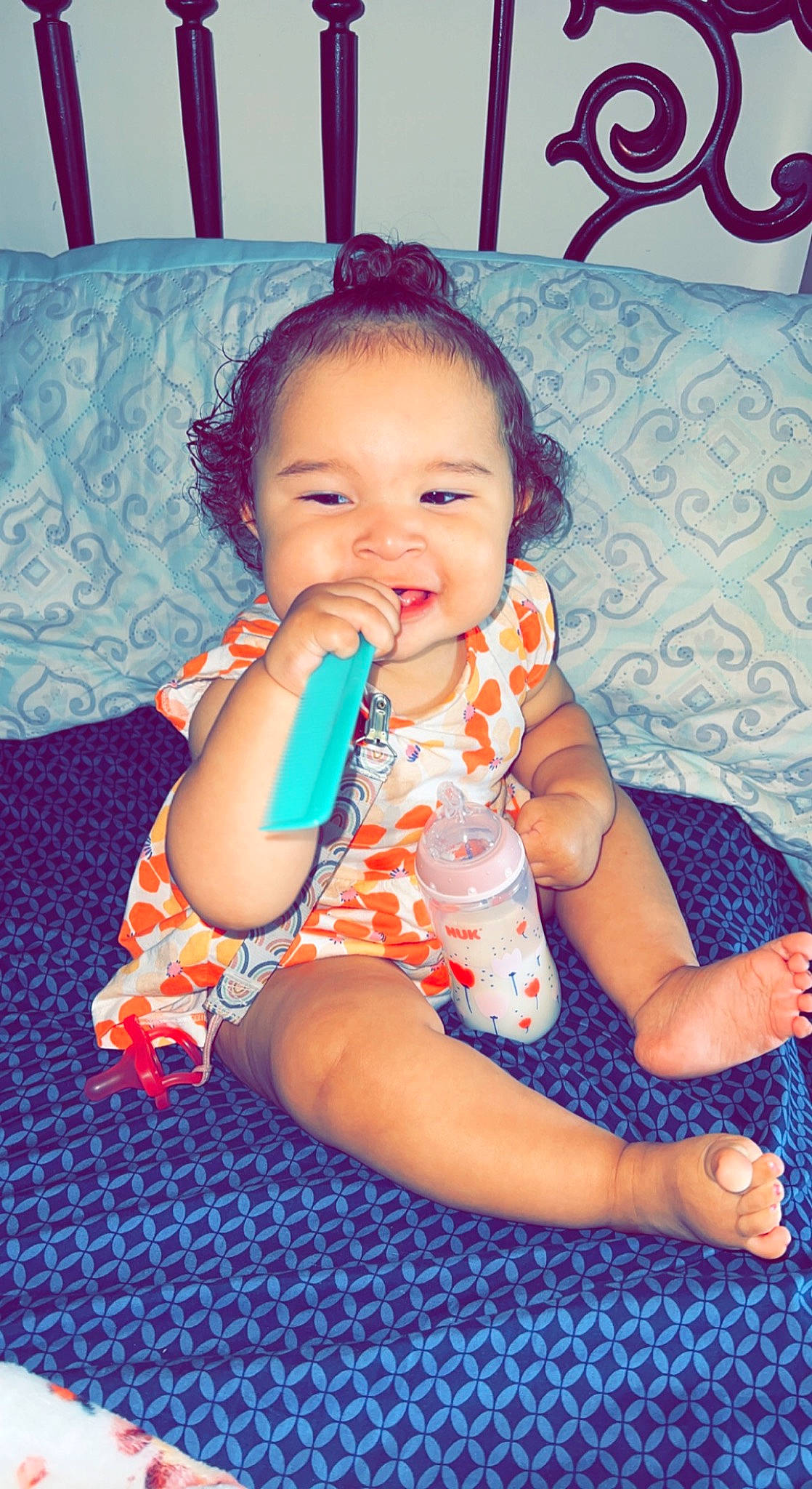 London is registered to the contest to win money with this photo: arm, baby_toddler_clothing, cheek, eye, face, facial_expression, finger, gesture, happy, head, human, iris, mouth, muscle, nose, organ, person, skin, smile, standing