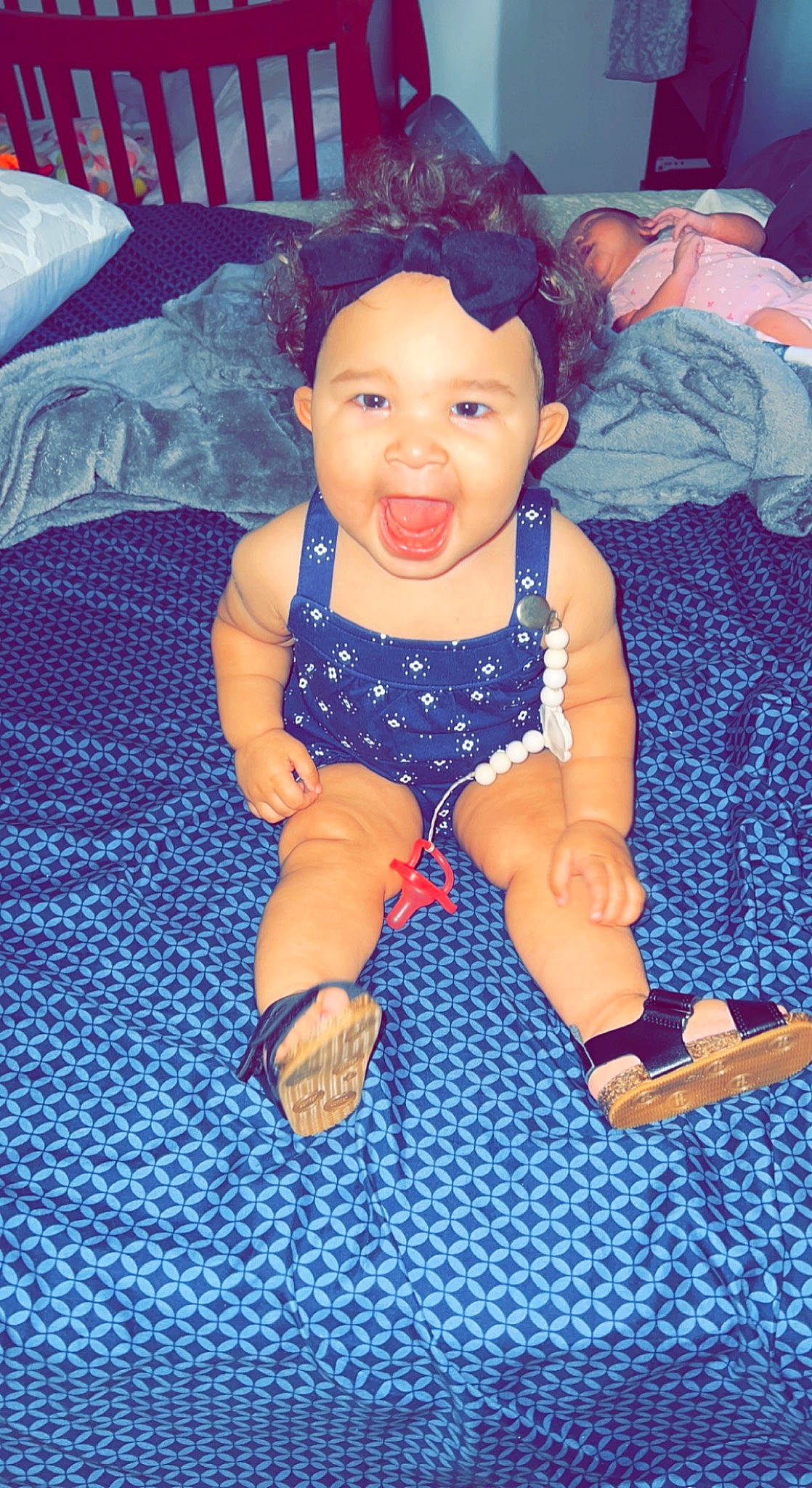 London is registered to the contest to win money with this photo: baby, baby_toddler_clothing, cheek, child, electric_blue, eye, foot, fun, happy, head, human_leg, iris, nail, pattern, person, sitting, skin, smile, thigh, thumb